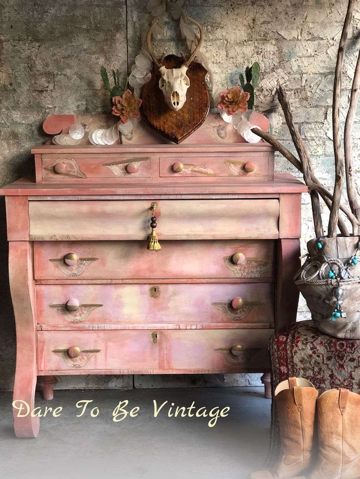 an old dresser with antlers on it and the words dare to be vintage