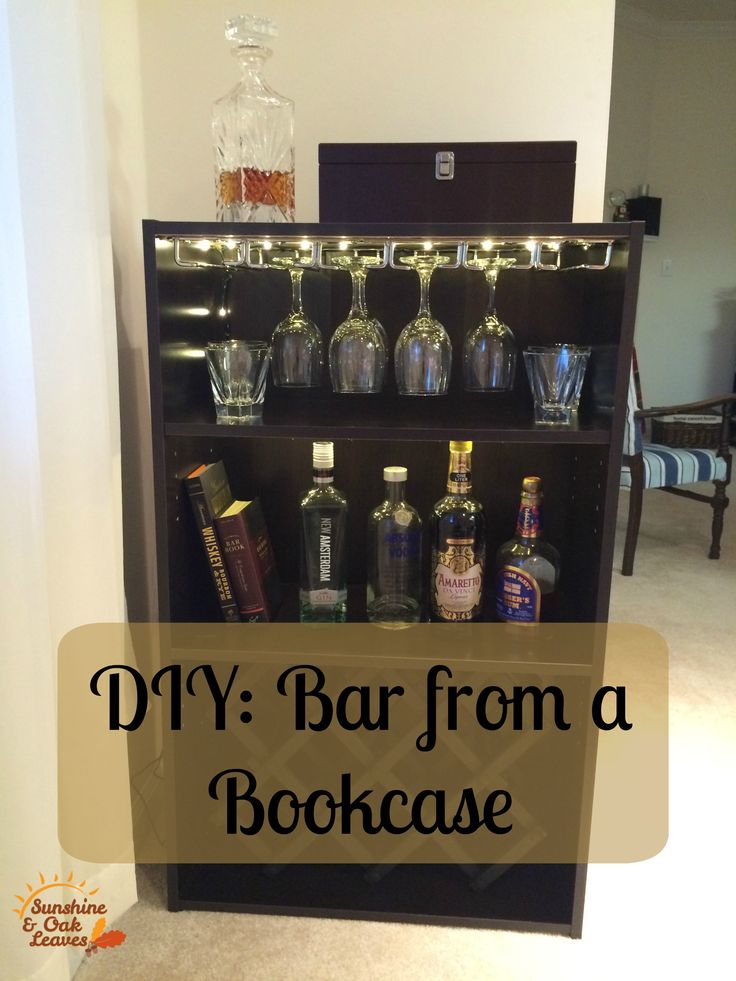 a bookcase filled with liquor bottles and glasses