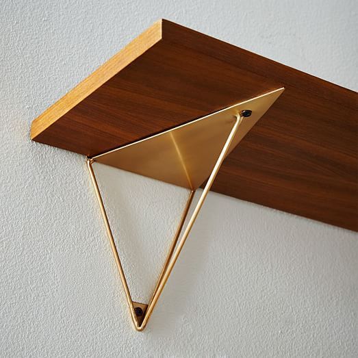 a wall mounted shelf with a wooden triangle on it's face and two metal brackets attached to the top