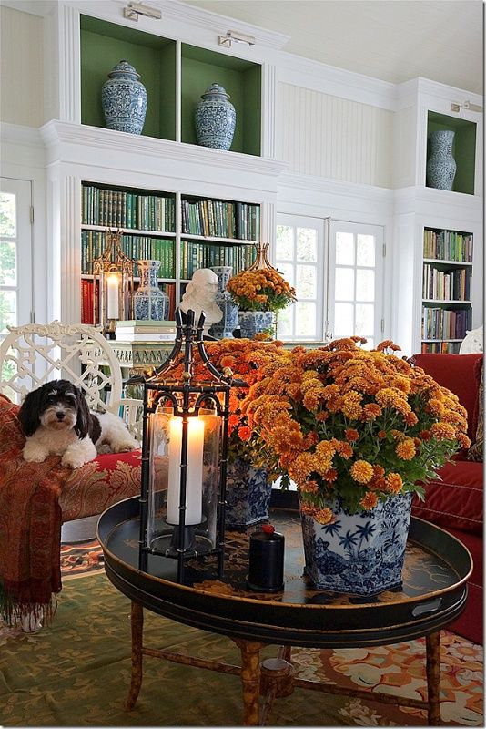 a living room filled with lots of furniture and flowers