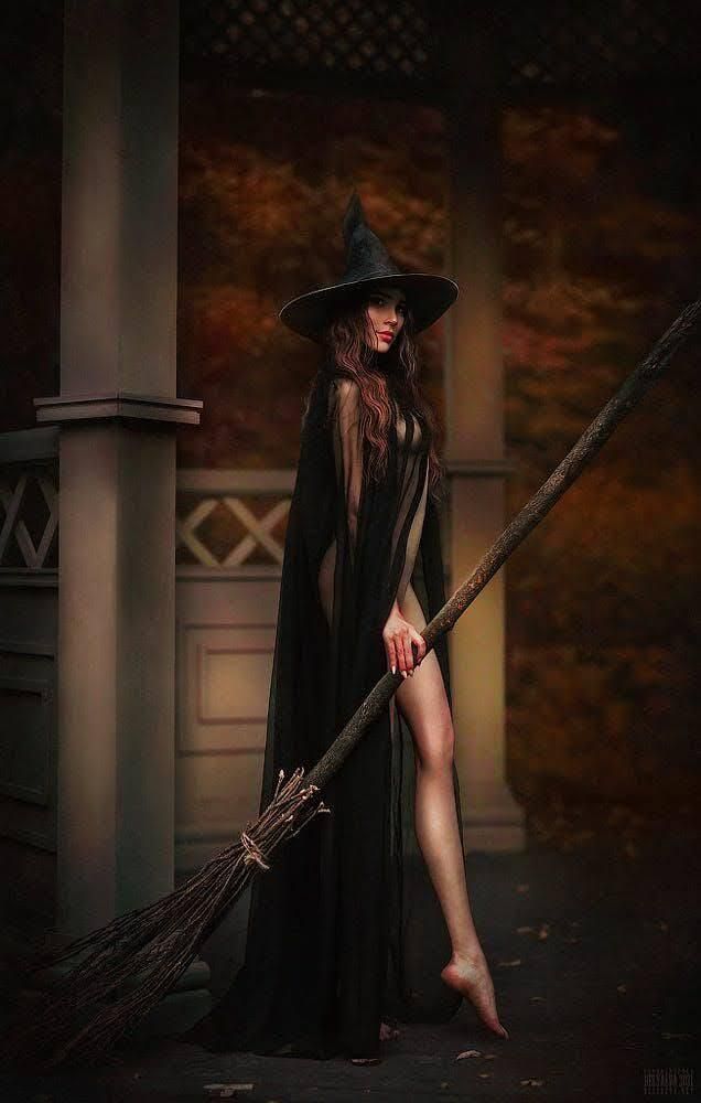 a woman dressed as a witch holding a broom