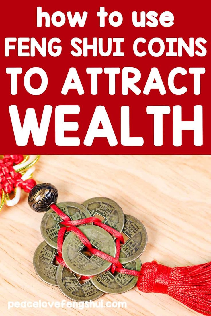 the words how to use feng shu coins to attract wealth on wooden table with red ribbon