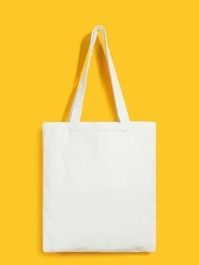 a white tote bag on a yellow background