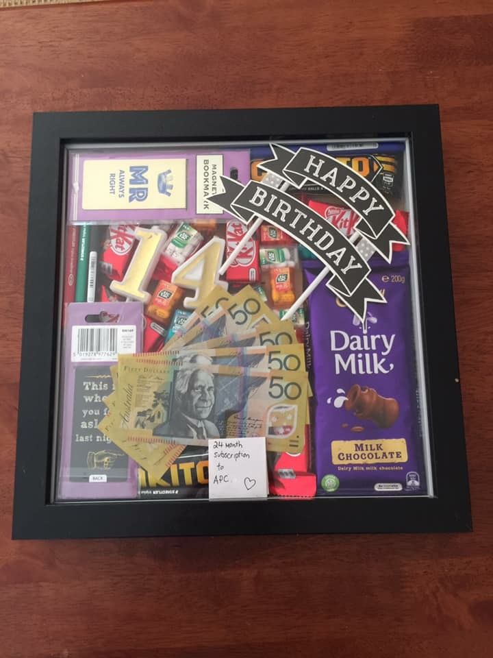 a wooden table topped with a framed poster