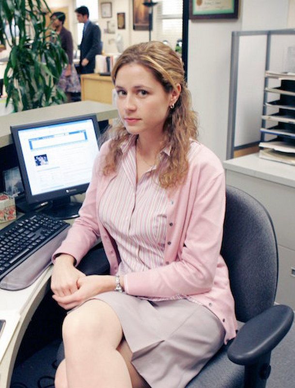 a woman sitting in an office chair next to a laptop computer