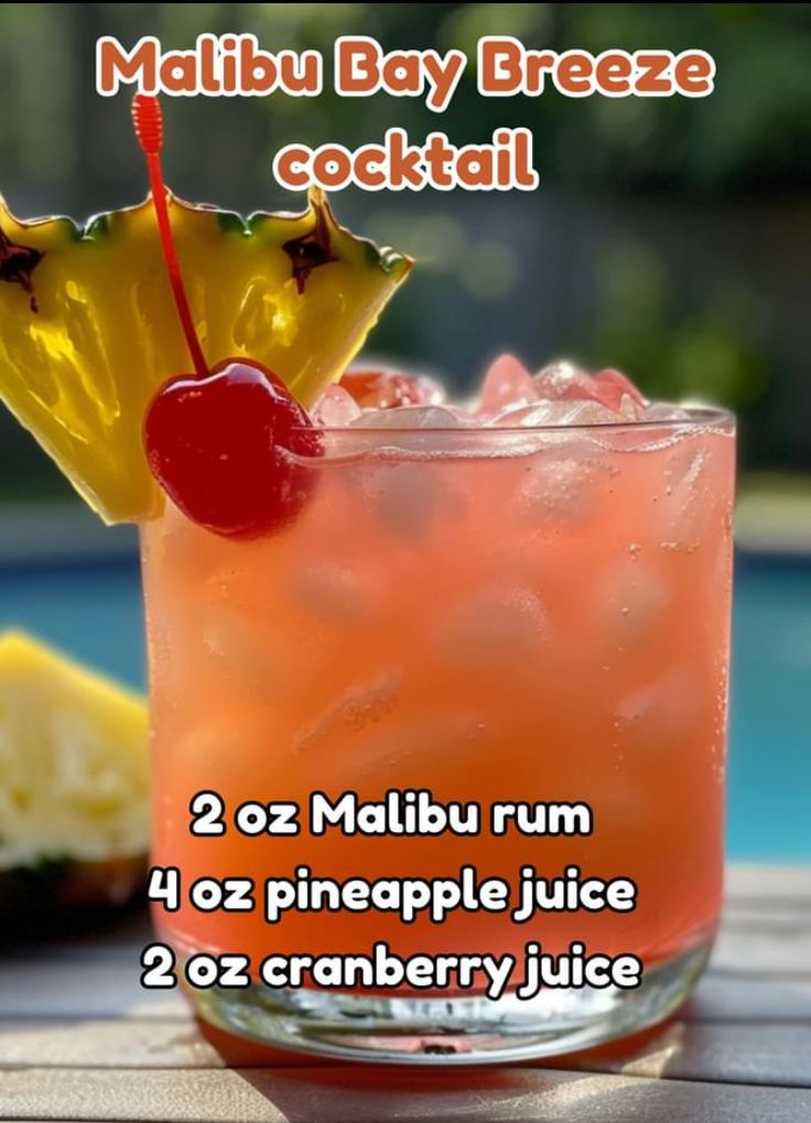 there is a drink with a cherry on the top and a pineapple in the middle