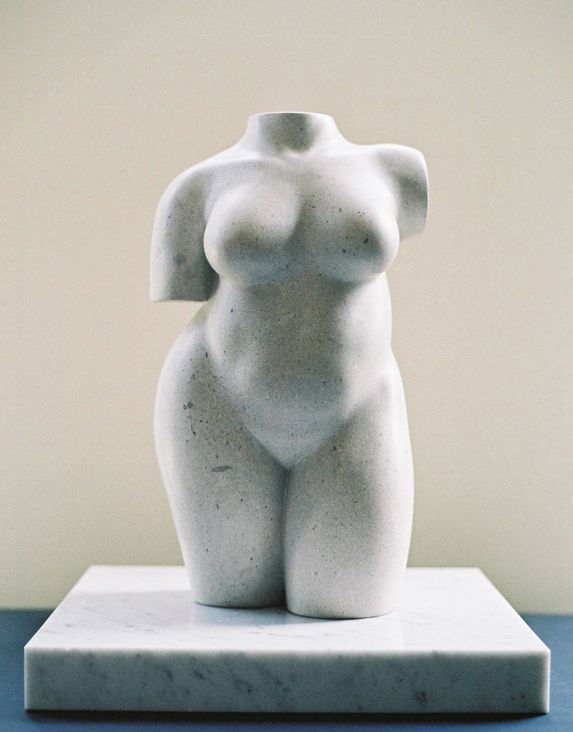 a white sculpture sitting on top of a blue table