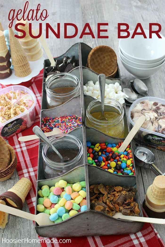 an ice cream sundae bar with lots of toppings and candy bars in it