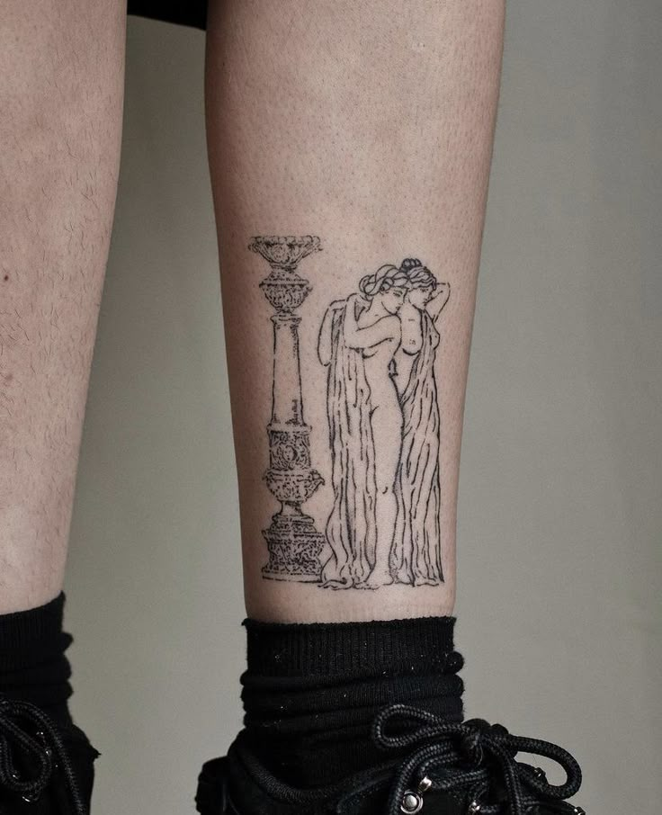 a woman's legs with tattoos on them