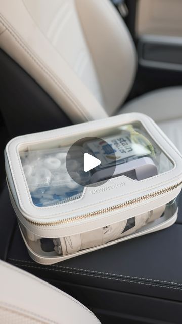 an empty plastic container sitting on top of a car seat