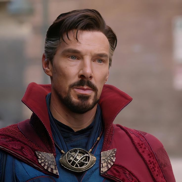 a close up of a person wearing a superman costume and a necklace with wings on it