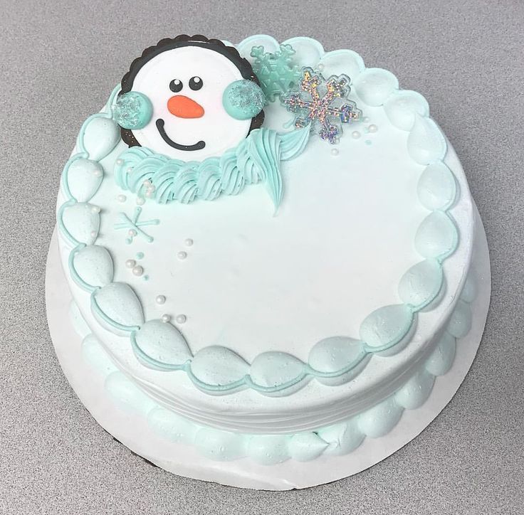 there is a frosted cake with a snowman on it