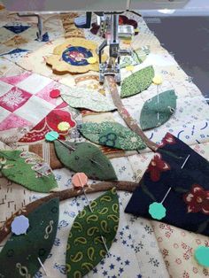 the sewing machine is working on some colorful pieces of fabric that have been sewn together