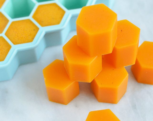 several orange and green hexagonal objects on a white surface