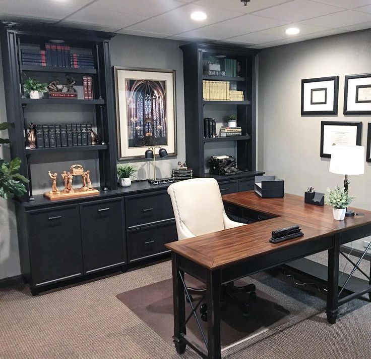 an office with black cabinets and white chairs