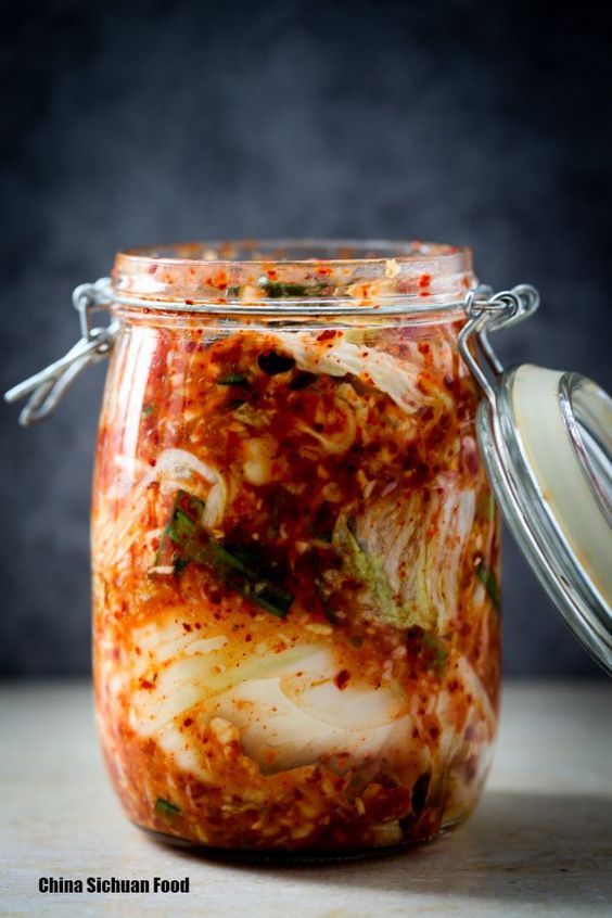 a glass jar filled with food sitting on top of a table