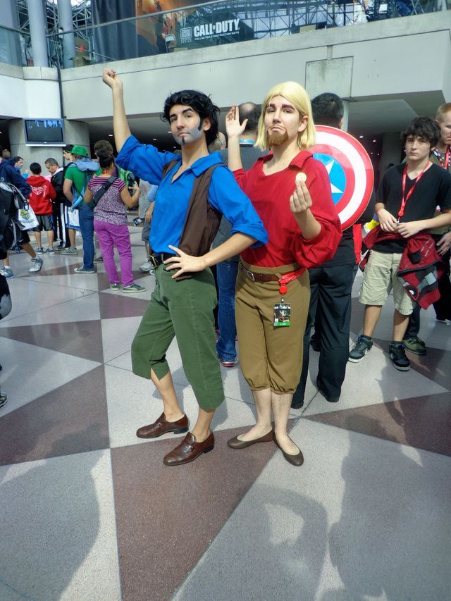 two people dressed up as captain america and the first person in costume are standing next to each other