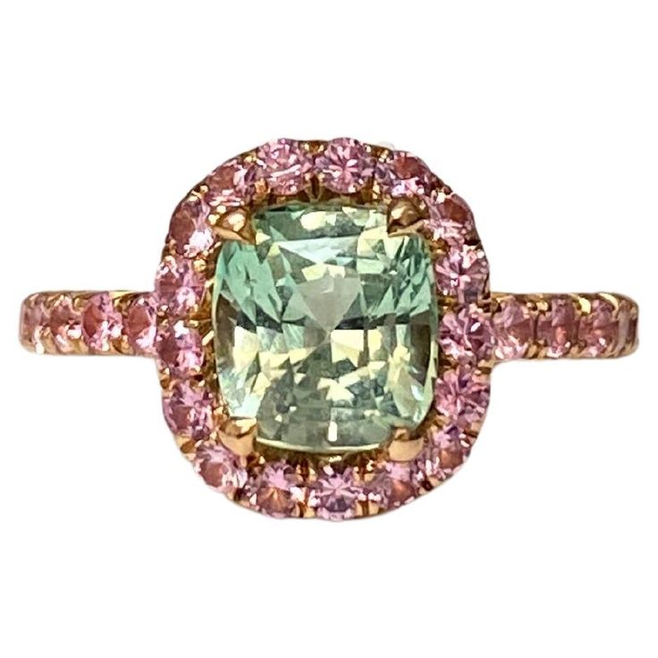 A beautiful chrysoberyl with an unusual pastel green colour set with light pink sapphires in 18k rose gold. The pink sapphires are set approximately 2/3 of the way around the band. The ring is hand-made in Geneva, and is a perfect fit for the little finger. The chrysoberyl weighs 1.66 ct and the 35 pink sapphires weigh 0.64ct. Colour Set, Pink Sapphire Ring, Green Colour, Pastel Green, Jewelry Maker, Geneva, Pink Sapphire, Color Set, Cocktail Rings