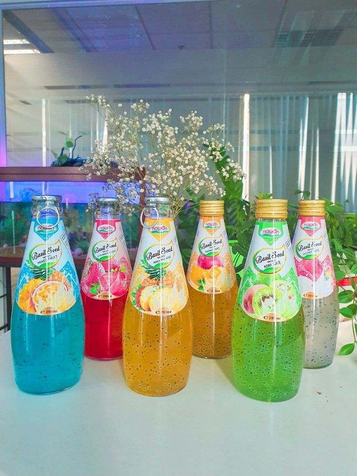 six bottles of liquid sitting on top of a table