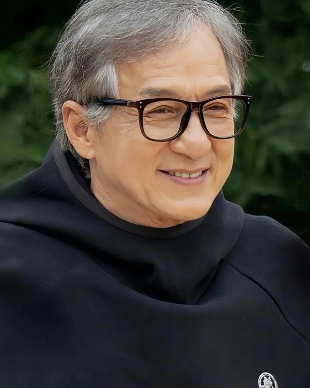 an older woman wearing glasses and a black cloak