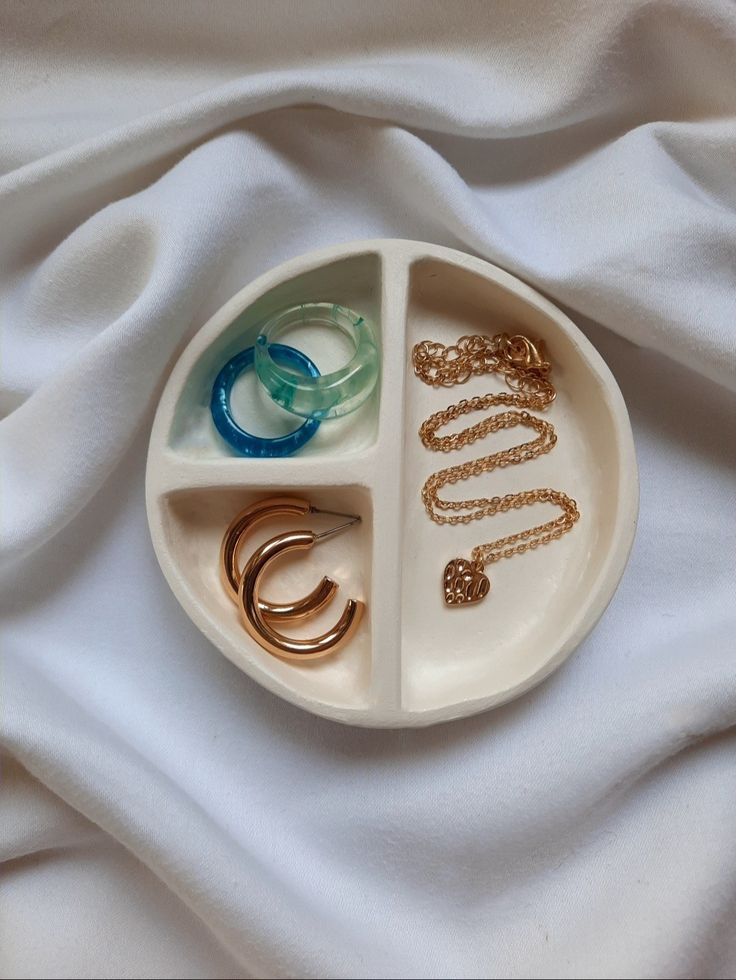 a white plate topped with rings and bracelets