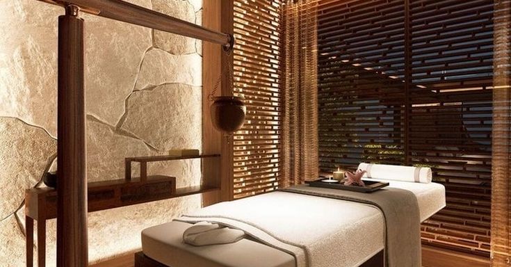 a spa room with a bed and wooden slats