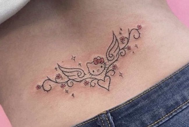 a woman's stomach with an angel tattoo on her side and stars around it