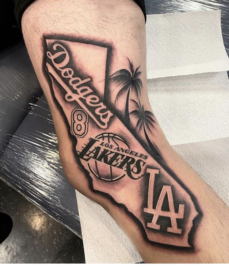 a man with a tattoo on his leg that has the los angeles lakers in it