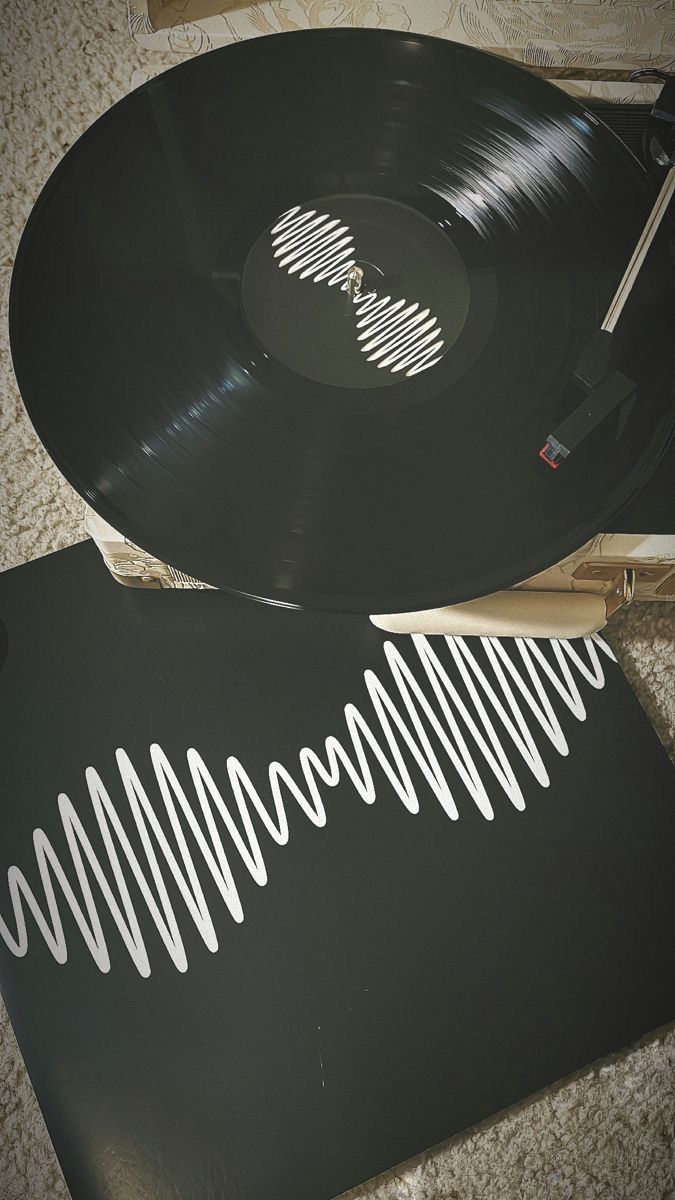 two vinyl records are laying on the floor