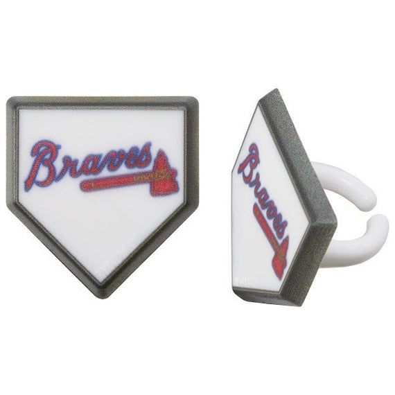 a couple of rings that are sitting on top of a white object with the word braves written on it