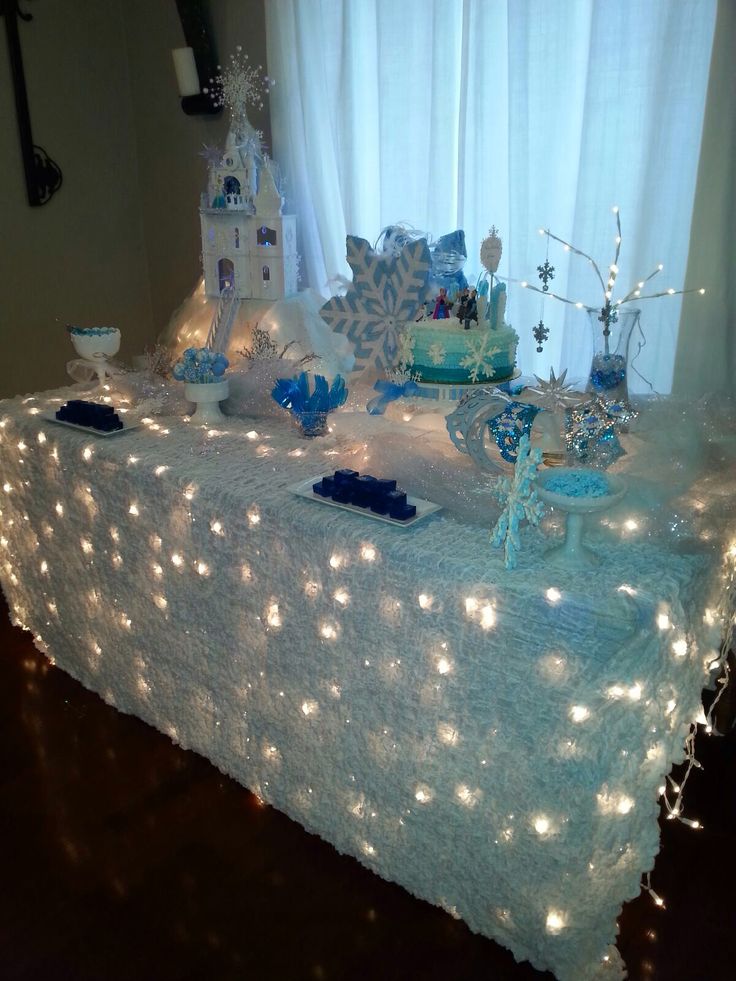 a table topped with lots of blue and white decorations