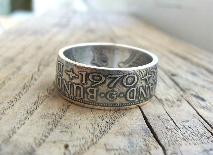 a ring with the words and numbers on it sitting on top of a wooden table