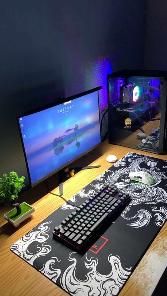 a desk with two computer monitors and a keyboard on it, along with a mouse pad