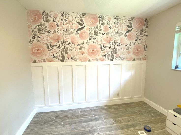 an empty room with flowers painted on the wall