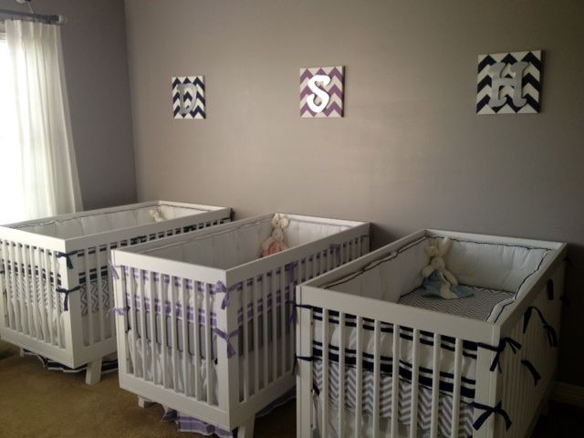 two baby cribs in a room with curtains on the windowsill and pictures above them