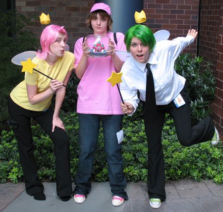 three people dressed in costumes posing for the camera