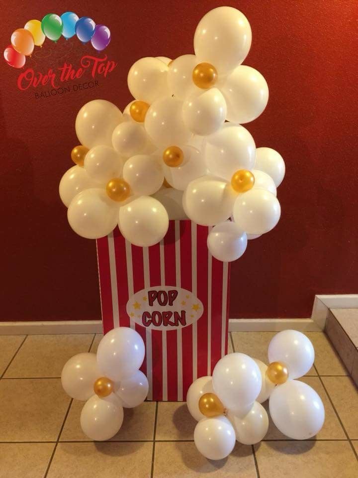 popcorn box filled with white and gold balloons