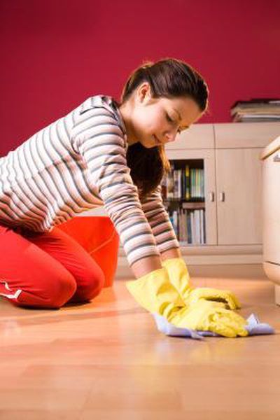 a woman cleaning the floor with a yellow mop