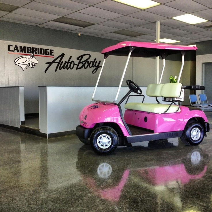 a pink golf cart is parked in the lobby