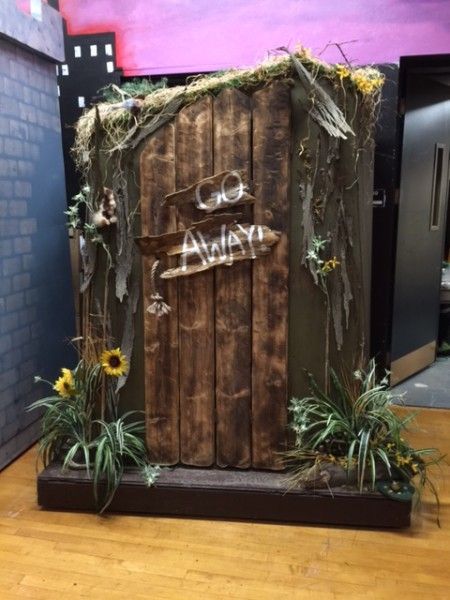 a wooden door with vines and flowers on it