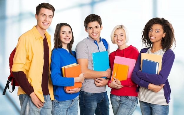 group of students with books smiling at the camera stock photo 1049782