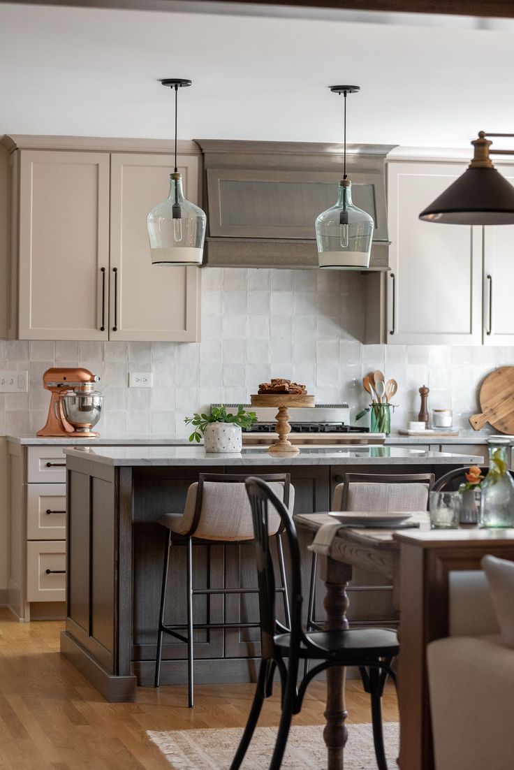 the kitchen is clean and ready to be used for cooking or eating, with stools around the island