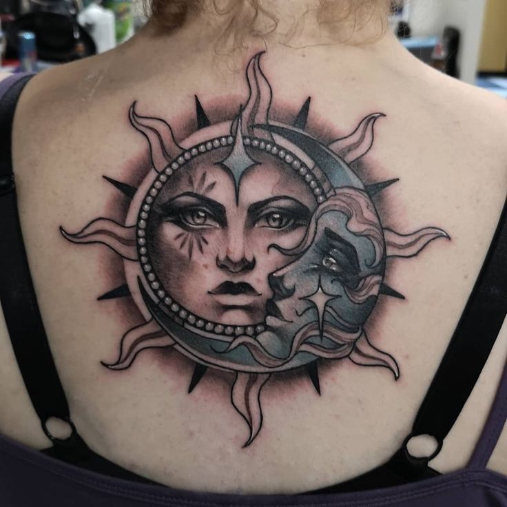 a woman with a sun and moon tattoo on her back