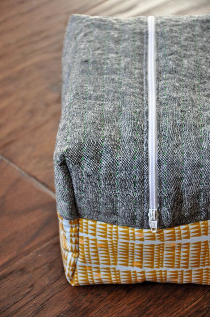 a zippered pouch sitting on top of a wooden floor