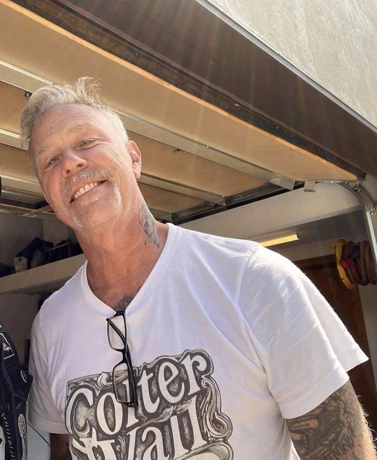 two men standing next to each other in front of a building with an awning