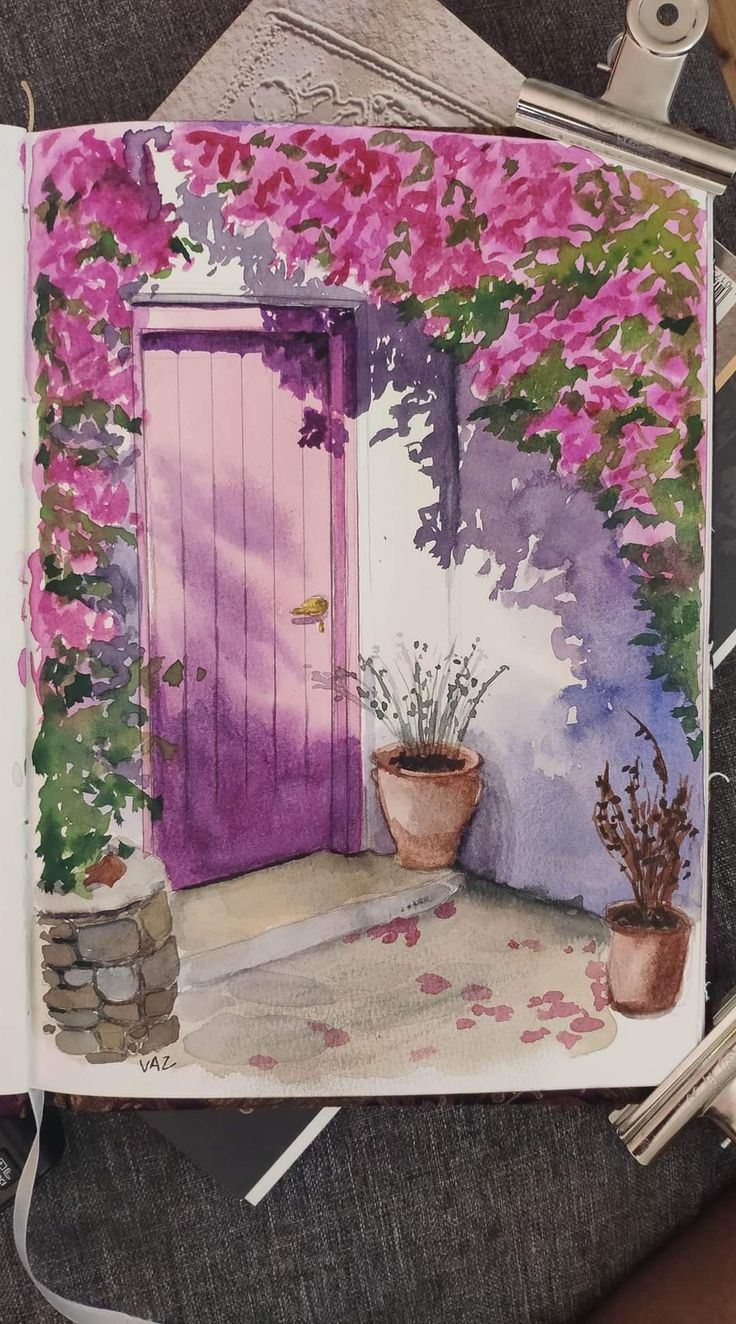 an open book with a painting of a pink door and potted plants next to it