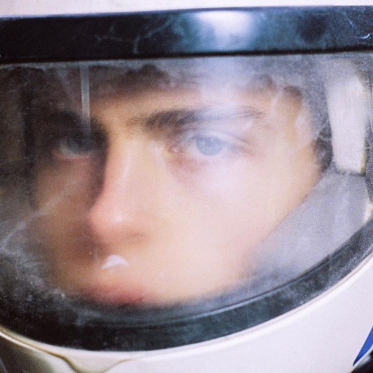 a close up of a person wearing a space suit with his face obscured by the helmet