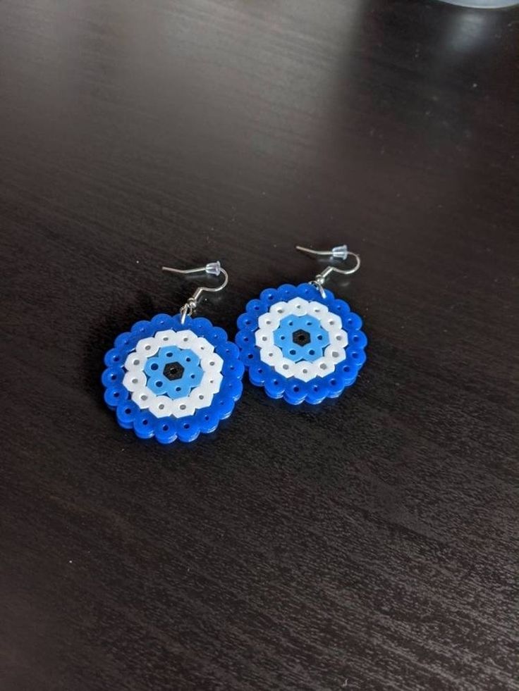 the earrings are made out of legos and have an evil eye design on them