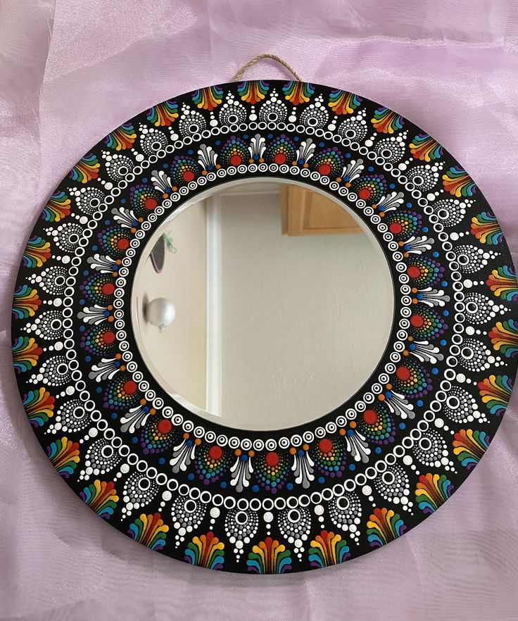 a colorful mirror hanging on the wall