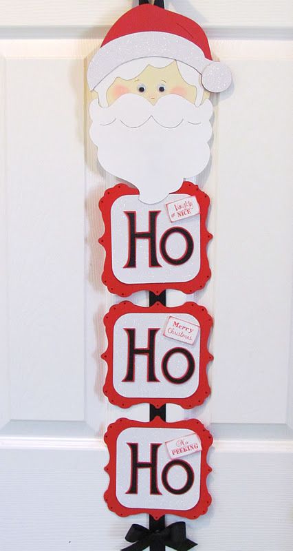 a door hanger with santa clause on it's face and the words ho ho ho